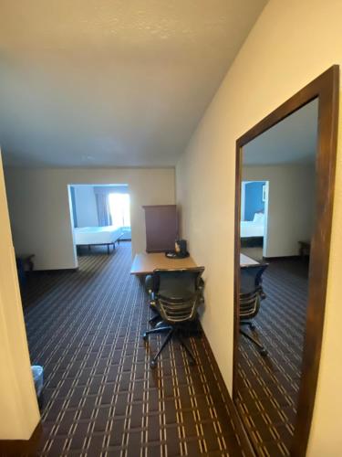 an office with a mirror and a desk with a laptop at Tombstone Grand Hotel, a Baymont by Wyndham in Tombstone