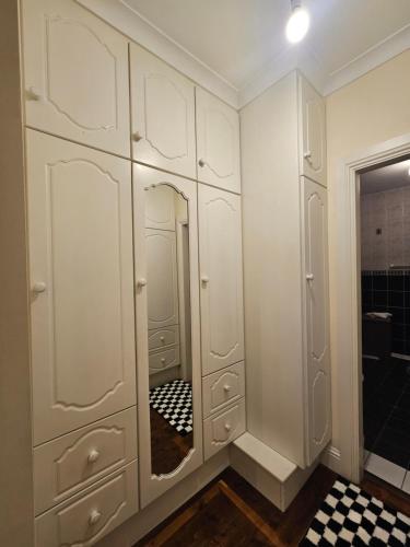 a dressing room with white cabinets and a mirror at Listowel Town in Listowel