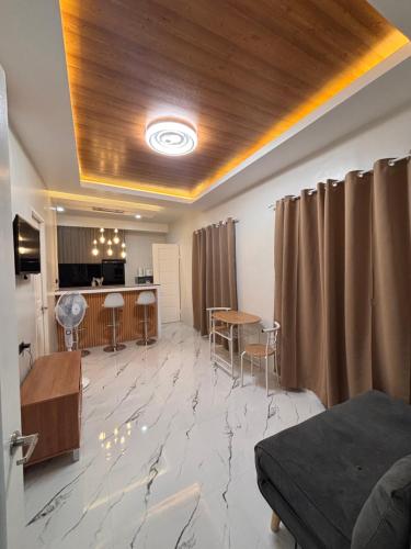 a living room with a table and a kitchen at ANG Residence in Dipolog
