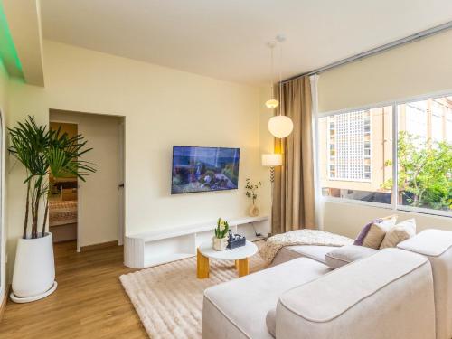 a living room with a white couch and a large window at 2 Bedroom for 3 guests in heart Sathorn with Balcony in Bangkok