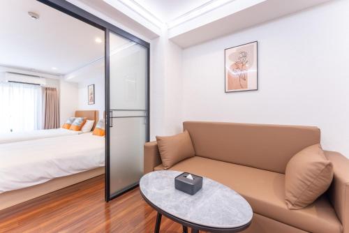 a living room with a couch and a bed at Tabist HOTEL UENO 39 in Tokyo