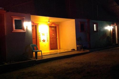 a house with a chair sitting outside at night at Casa Paliton Siquijor near Beach in Siquijor