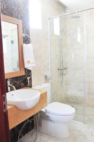 a bathroom with a toilet and a sink and a shower at Sen Vàng Luxury Hotel in Nha Trang