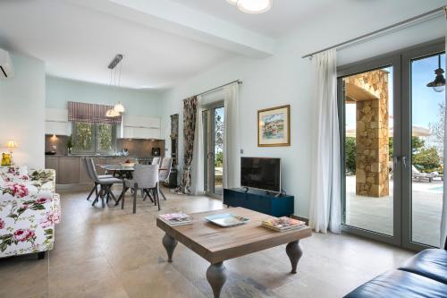 a living room with a couch and a table at Afrodite Luxury Villa in Svoronata