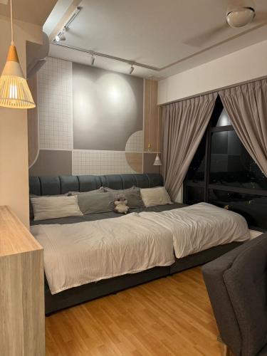 a bedroom with a large bed with a teddy bear on it at Imperium Resident Kuantan Eleven-7 in Kuantan