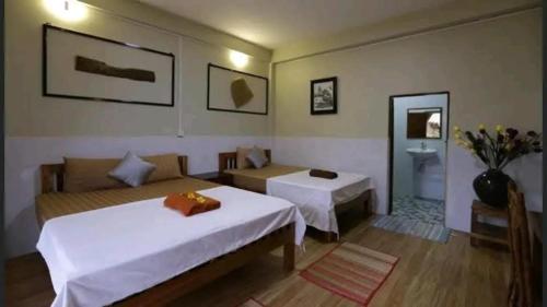 a hotel room with a bed and a couch at Fish Island Bungalows in Kampot
