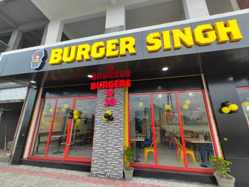 a burger shop with a sign on the front of it at Skylight Suites in Doiwāla