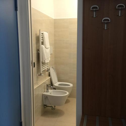 a bathroom with a toilet and a sink at Hotel Athena in Pesaro