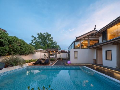 a swimming pool in the backyard of a house at Lijiang Jinghua Inn in Lijiang