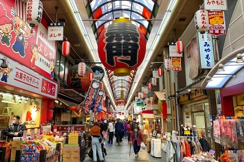 a shopping mall with people walking in the arcade at Nipponbashi Luxe Hotel in Osaka