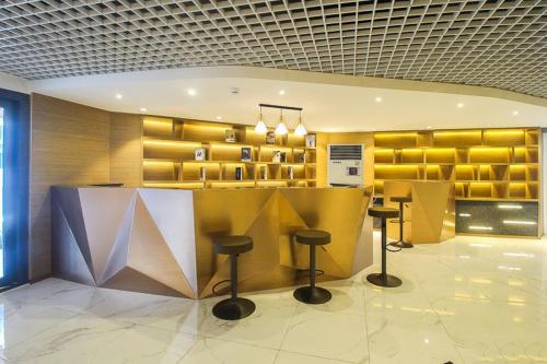 a lobby with a bar with stools in it at Artisan Ratchada Spacious 2BR Condos in Bangkok