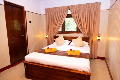 Ένα ή περισσότερα κρεβάτια σε δωμάτιο στο Le Living Nuwara Eliya