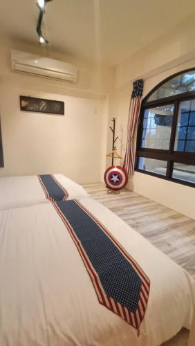 a bedroom with a large bed with an american flag at Snail B&B in Pinghe