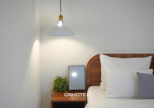 a bedroom with a bed and a mirror on a table at QR Hotel Dalat in Xuan An
