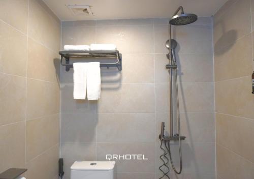 a shower stall in a bathroom with a toilet at QR Hotel Dalat in Xuan An