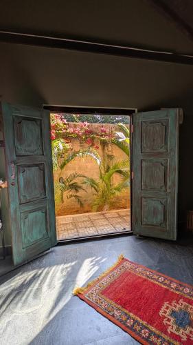 an open door to a room with a rug and an open window at 501 Thumpalai Road in Point Pedro