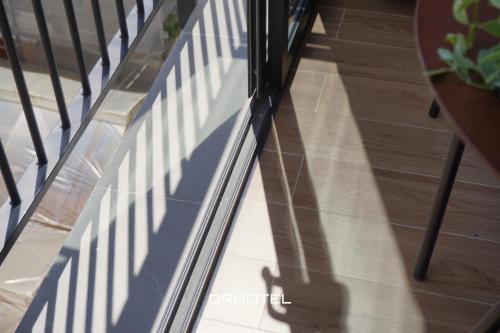 a shadow of a railing on a staircase at QR Hotel Dalat in Xuan An
