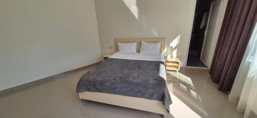 a bedroom with a large bed in a room at Goga Guest House in Kvariati