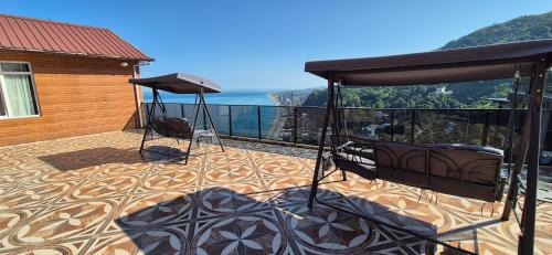 a deck with a view of the ocean on a house at Goga Guest House in Kvariati