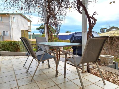 a table and chairs sitting on a patio at Jennie's Place in Port Moonta
