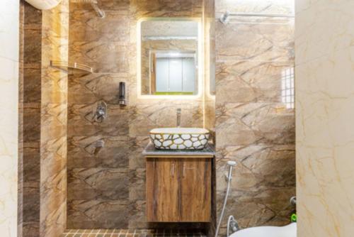 a bathroom with a sink and a mirror at Super Luxury Independent Studio in Gurgaon