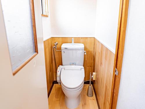 a bathroom with a toilet in a small room at The M OTAMACHI in Nakatsugawa