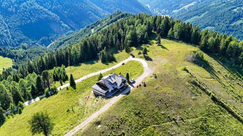 an aerial view of a house on top of a hill at JAUCHZA! Berg Apartments mit 360 Grad Blick in Innerkrems