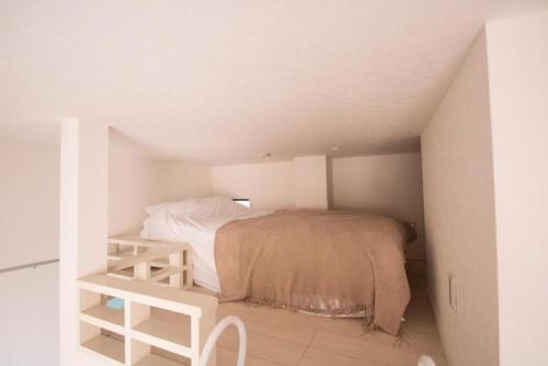 a small bedroom with a bed in a attic at SCS105, 20mins to Skytree, 30 mins to Ueno,Ginza in Tokyo
