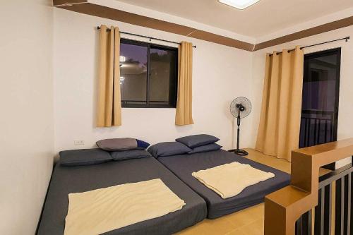 a bedroom with a large bed and a window at The Hidden Escape in Sampong