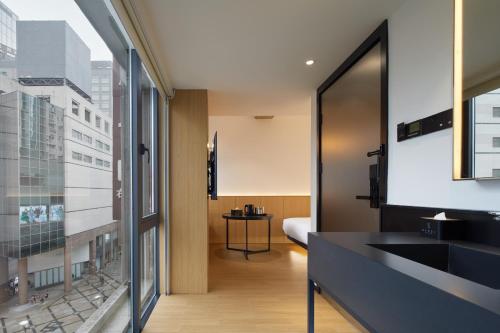 a bathroom with a sink and a window at SFEEL设计师酒店Designer Hotel成都太古里春熙路步行街店 in Chengdu