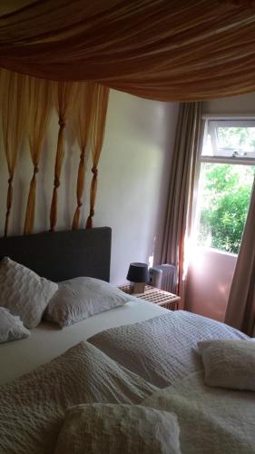 a bedroom with a large bed and a window at De Vuurplaats in Drachten