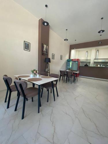 a dining room with a table and chairs in a room at Guest House Deme in K'obulet'i