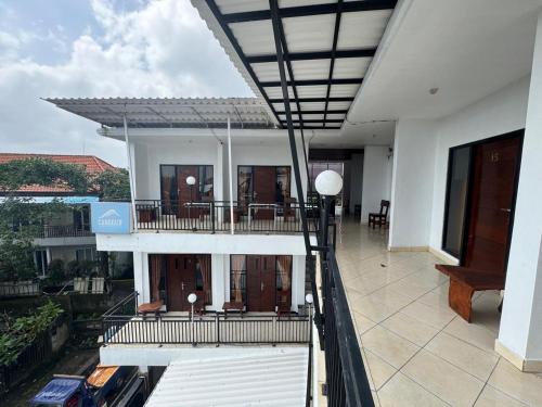 a balcony of a house with a view of a building at Canggu 77 Guest House in Badung
