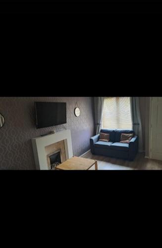 a living room with a couch and a tv at Family Room in a 2 bed room house in Thornaby on Tees