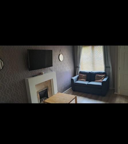 a living room with a couch and a fireplace at Family Room in a 2 bed room house in Thornaby on Tees