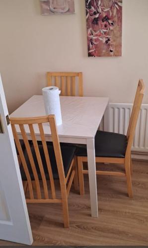 a dining room table with two chairs and a white table at Family Room in a 2 bed room house in Thornaby on Tees