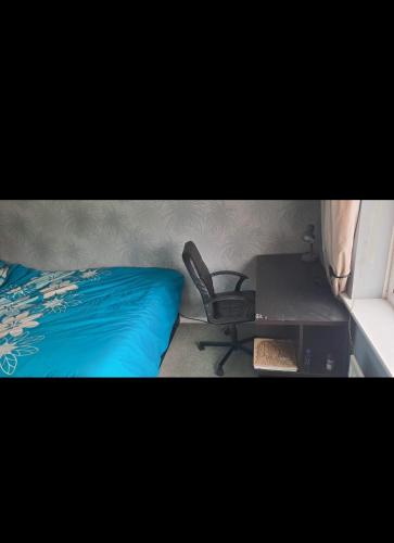 a bedroom with a desk and a chair next to a bed at Family Room in a 2 bed room house in Thornaby on Tees