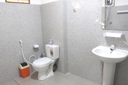 a bathroom with a toilet and a sink at Sigiriya Palace View in Sigiriya