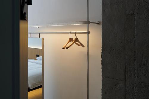 a pair of mitts hanging on a wall next to a bedroom at SFEEL设计师酒店Designer Hotel成都太古里春熙路步行街店 in Chengdu