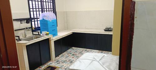 a small kitchen with a sink and a counter at Alfian Homestay in Johor Bahru
