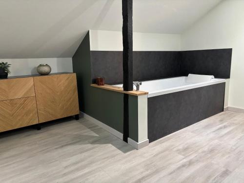 a bathroom with a sink and a bath tub at Côté Gîtes Cassel in Cassel