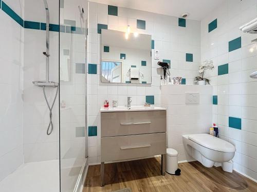 a bathroom with a shower and a sink and a toilet at La Ferme de Kerraoul in Combrit