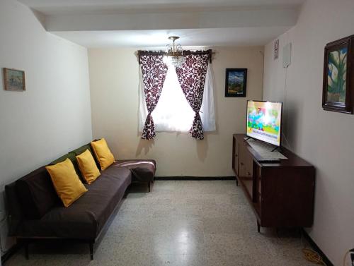 a living room with a couch and a window at Departamento entero en Lomas de Sotelo cerca de Polanco in Mexico City