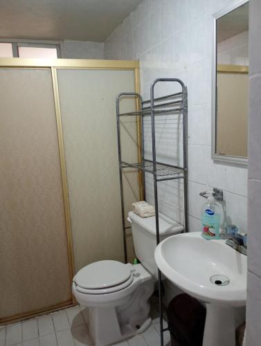 a bathroom with a toilet and a sink at Departamento entero en Lomas de Sotelo cerca de Polanco in Mexico City