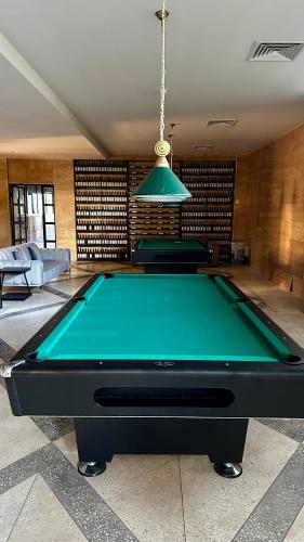 a pool table in a living room with a ping at Sea Romantic Apartment in Gonio
