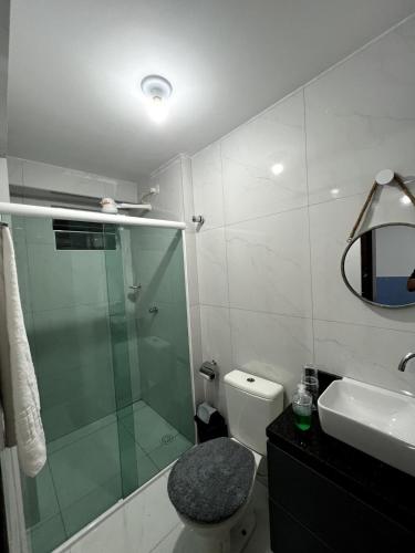a bathroom with a shower and a toilet and a sink at Summer Apartment in Porto De Galinhas