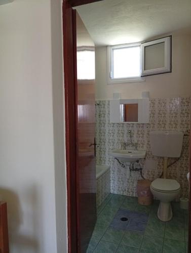 a bathroom with a toilet and a sink at ANNAS COTTAGE in Skala Sotiros