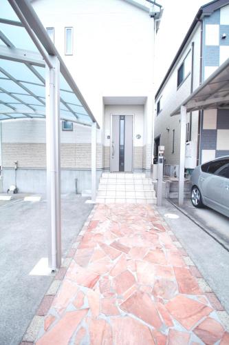 a building with a stone walkway in a parking lot at 22minutes by car to Nagoya Station 2parking 