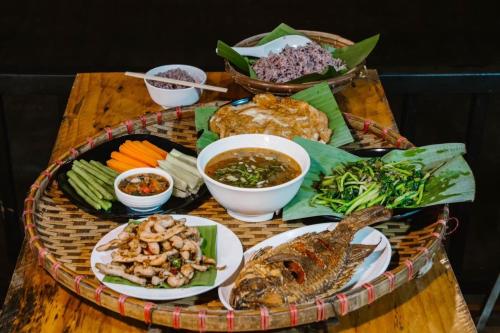 a table topped with a tray of food with different foods at K2 Phahee in Ban Ko Doi Tung