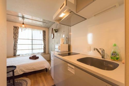 Postel nebo postele na pokoji v ubytování Fare Metallo Tokyo Nakano 11-room Hotel